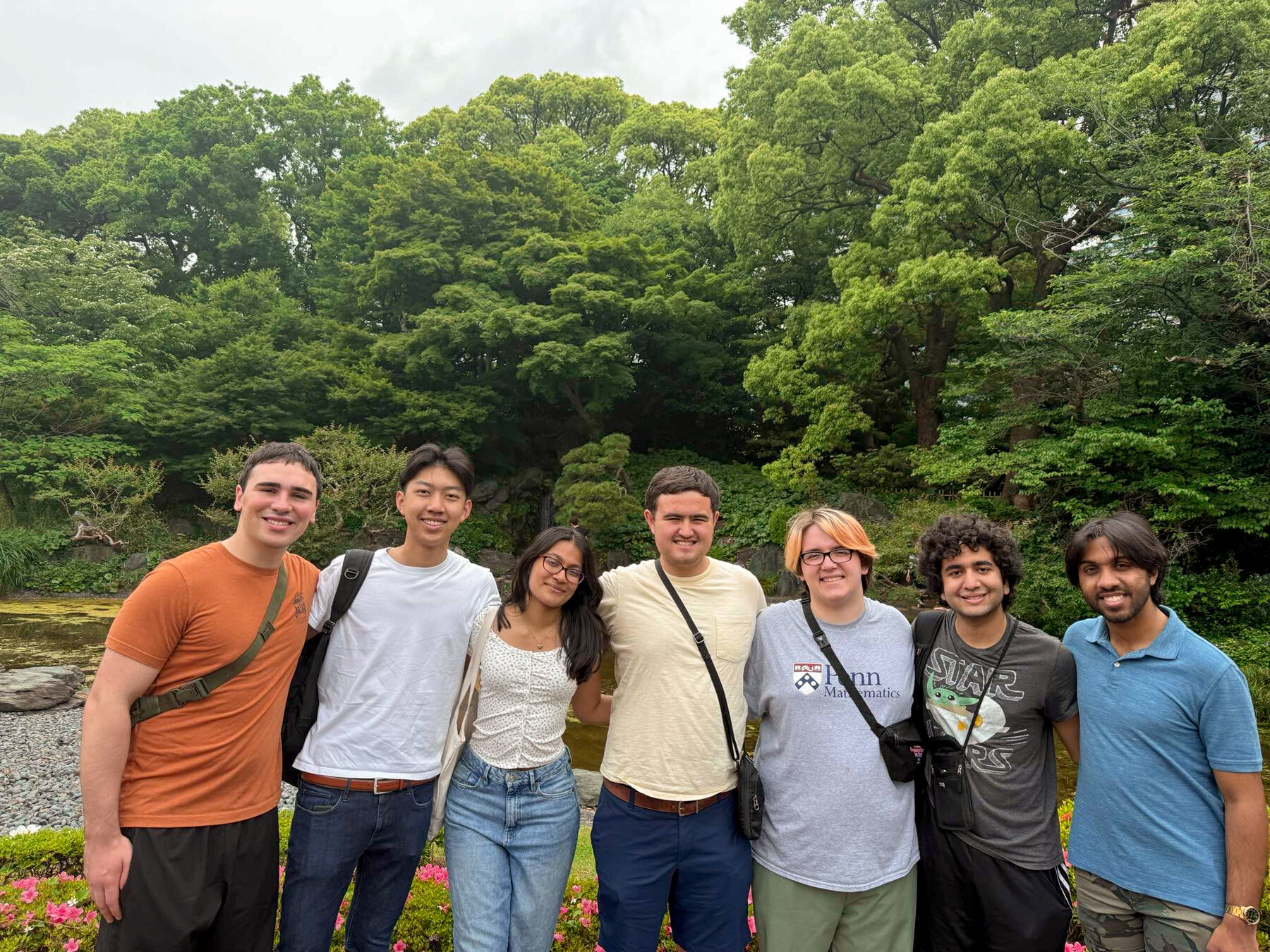 glee cluib members standing outside with trees behind them
