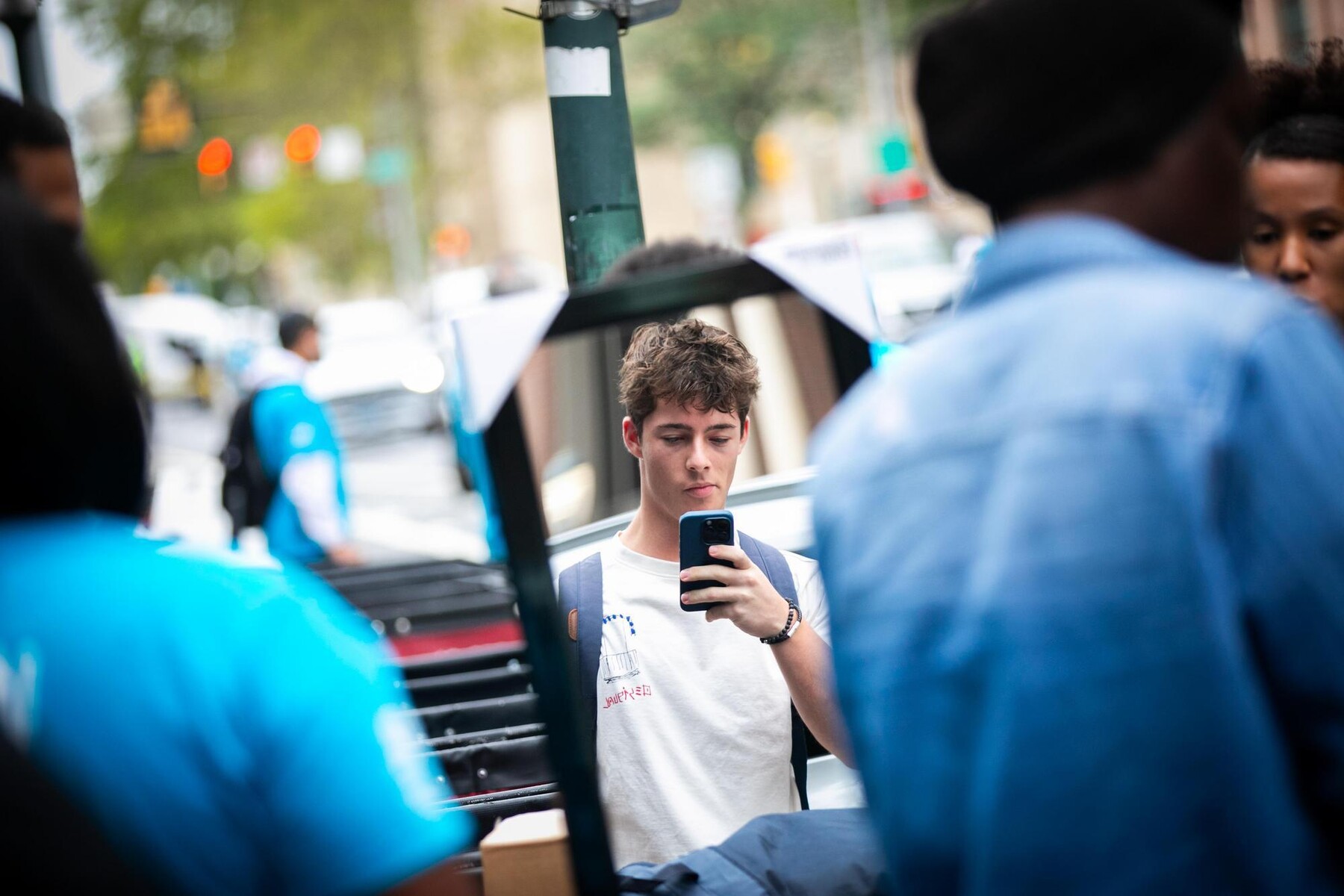 A student takes a selfie in the reflection of a mirror during Move-In