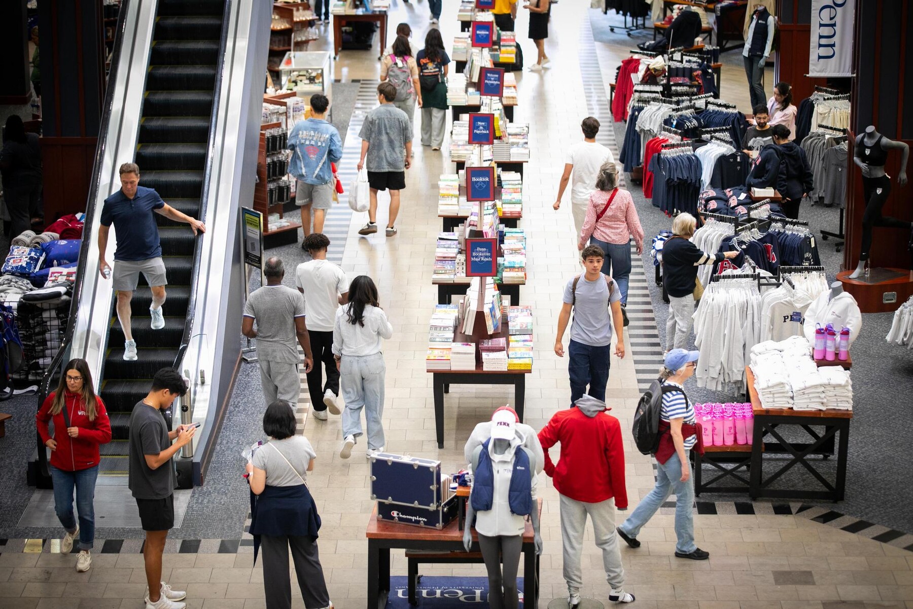Students and families walking through the Penn Bookstore.