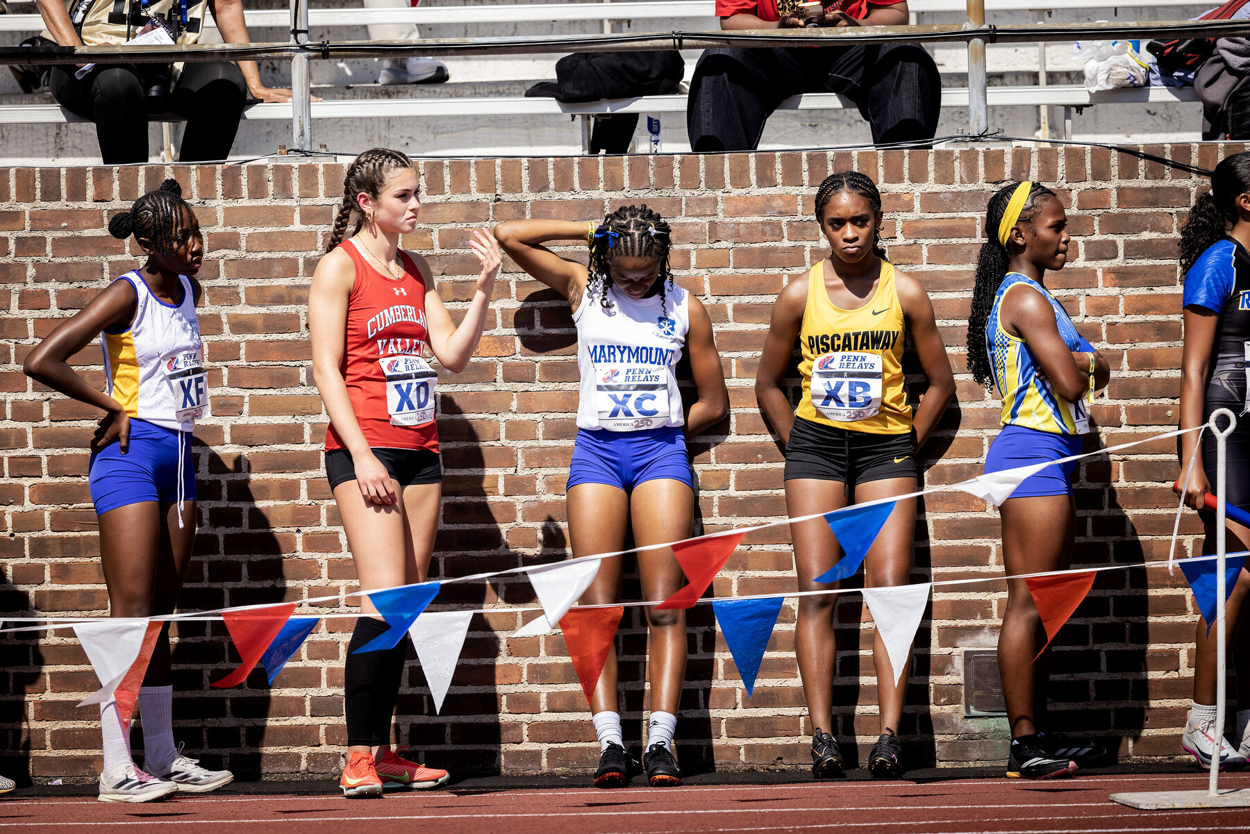 Runners on the track at Franklin Field waiting before a race.