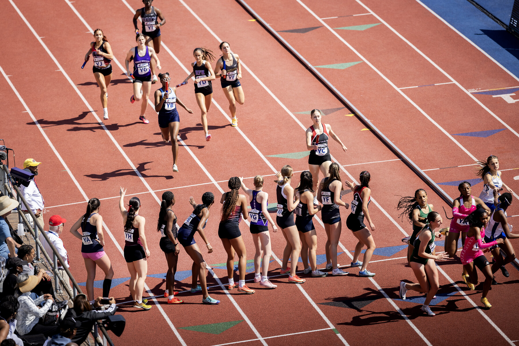 Runners on Franklin Field during a relay race.