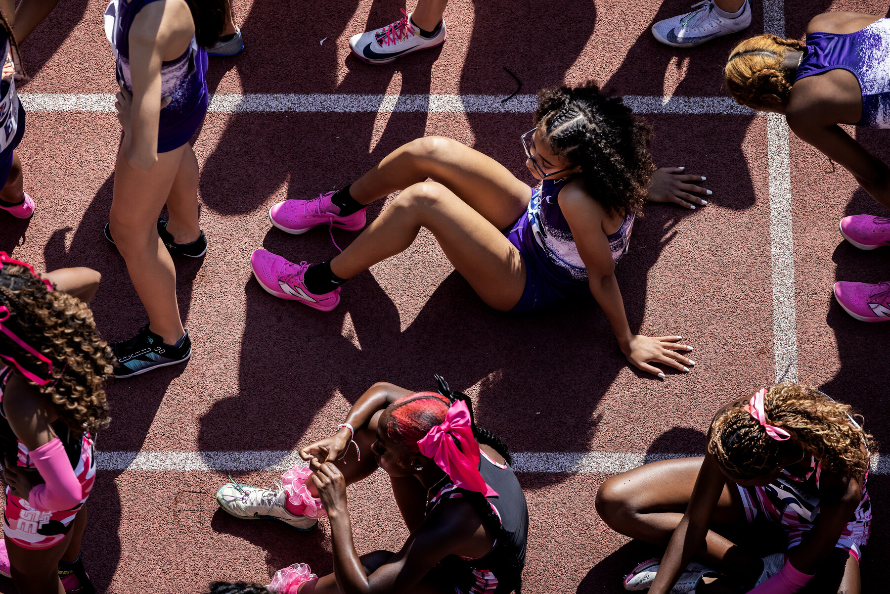 Runners resting before a race on the track at Franklin Field.