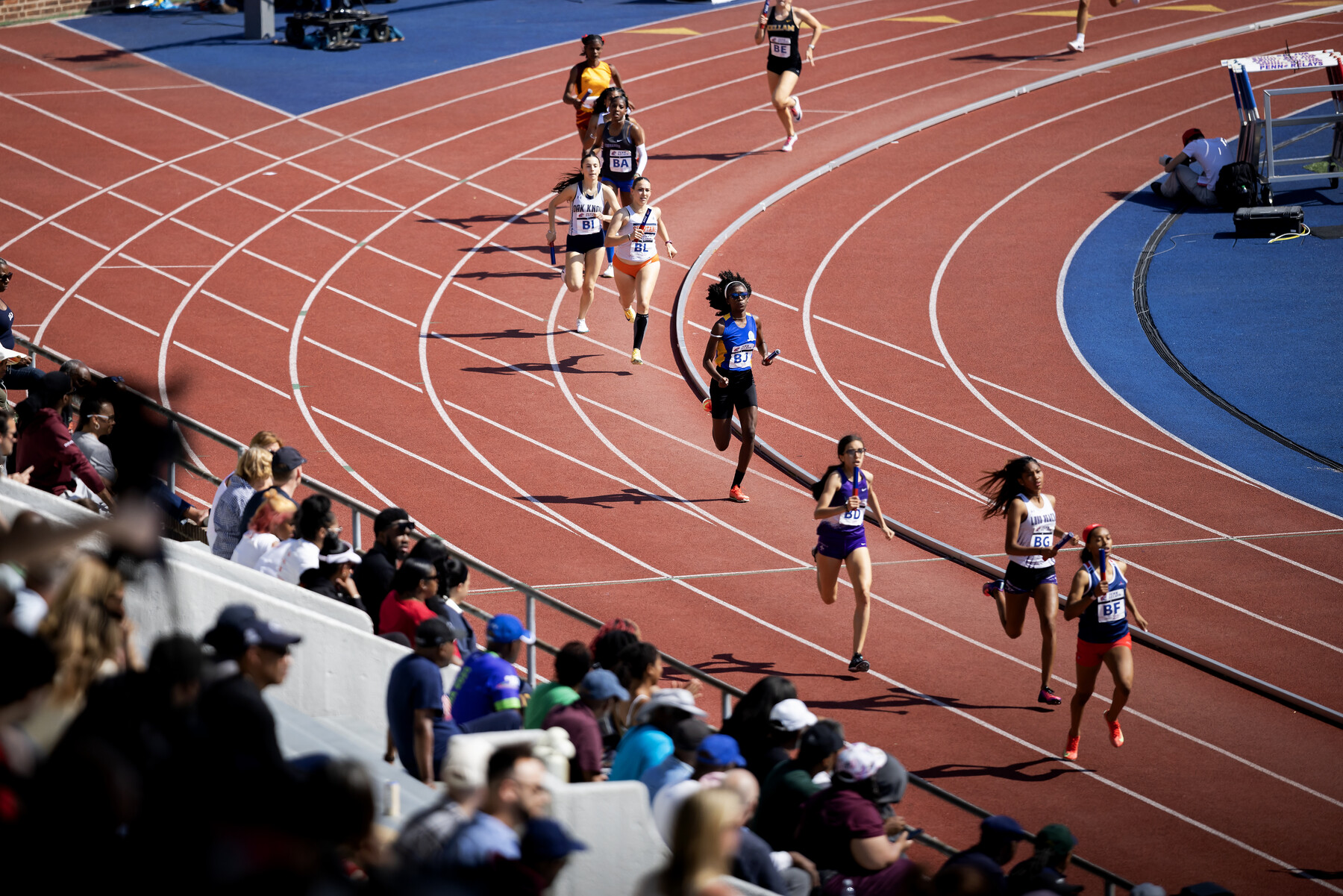 runners on the track at Franklin Field during the Penn Relays.