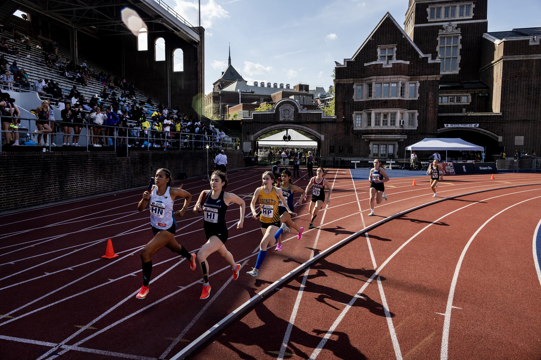 Runners on the track at Franklin Field during the Penn relays.