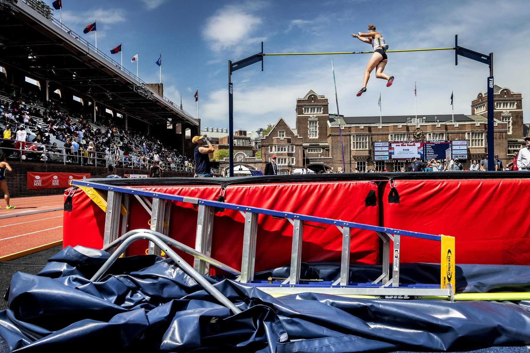 A pole vaulter mid-air on Franklin Field.
