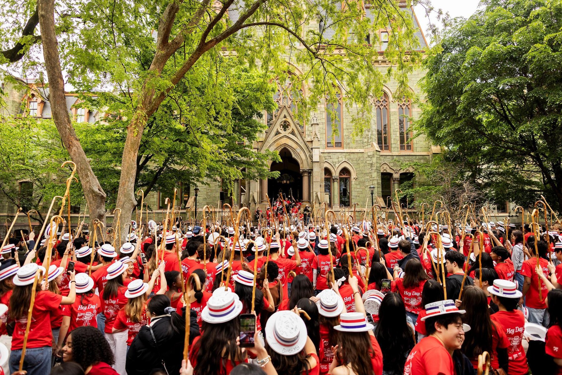 The Class of 2027 in front of College Hall waving their canes on Hey Day.