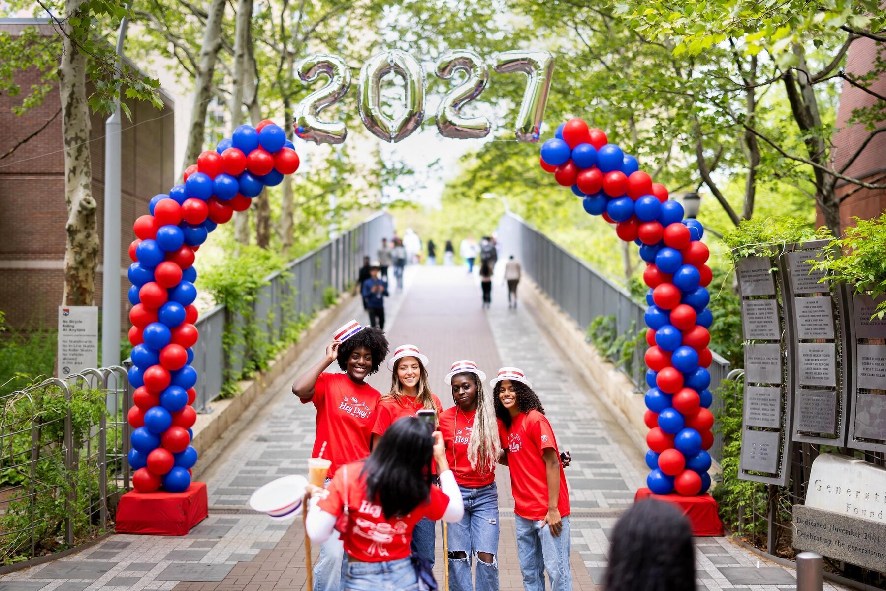 Students taking photos under the 2027 balloon arch on Locust Bridge on Hey Day.