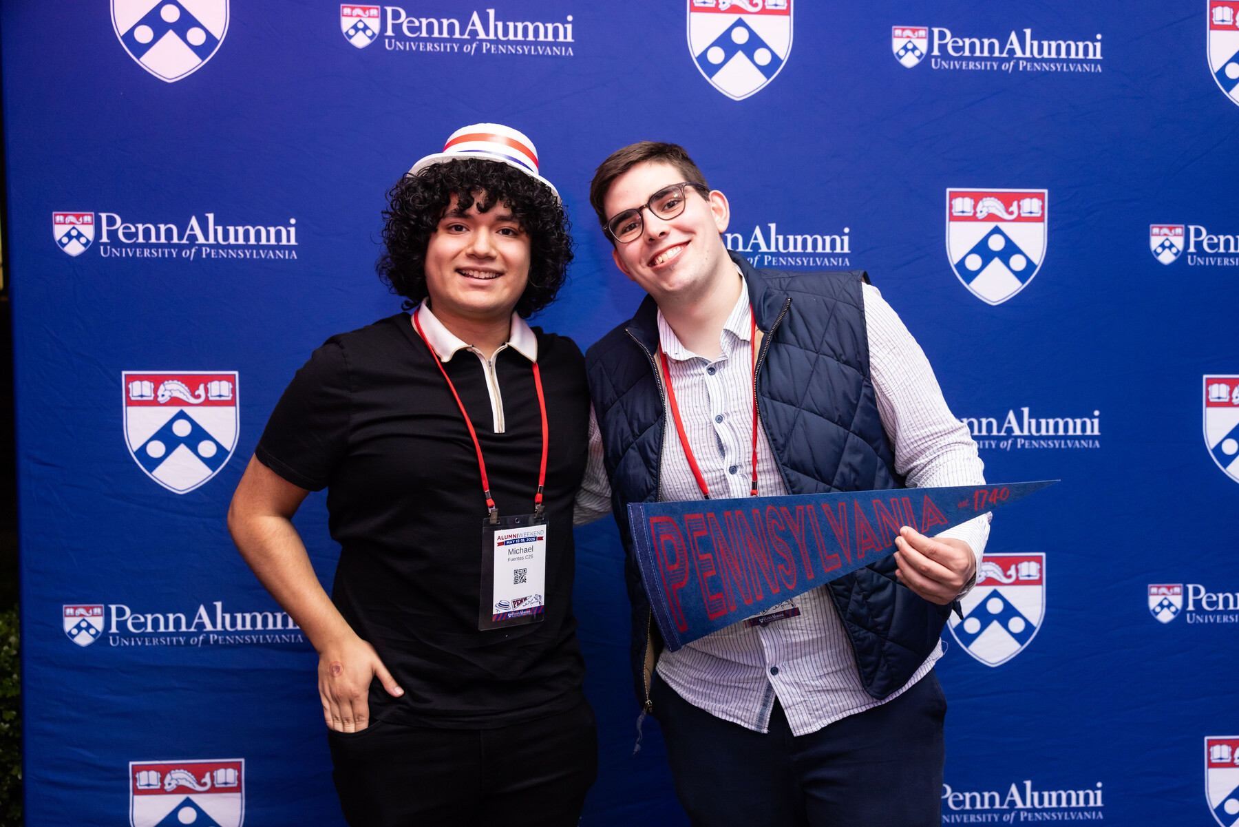 Two Penn alumni at a Penn Alumni step and repeat during Alumni Weekend.