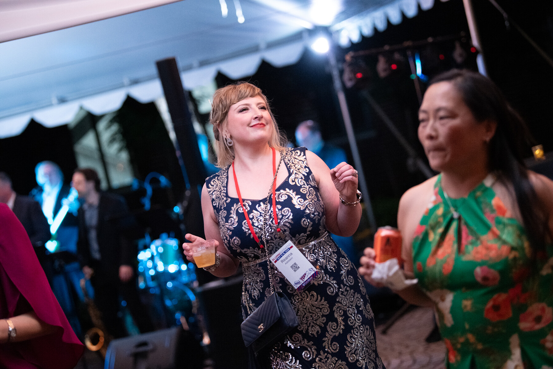 People dancing under a tent at night during alumni weekend.