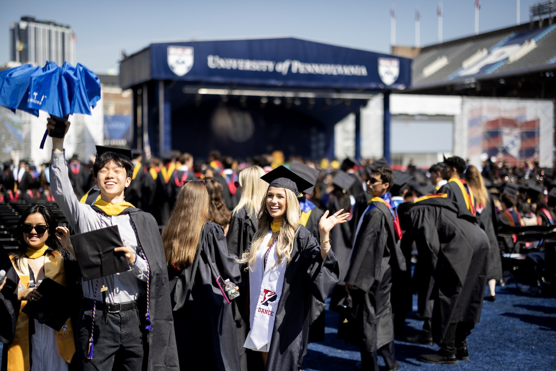 Students waving on franklin field before the commencement ceremony.