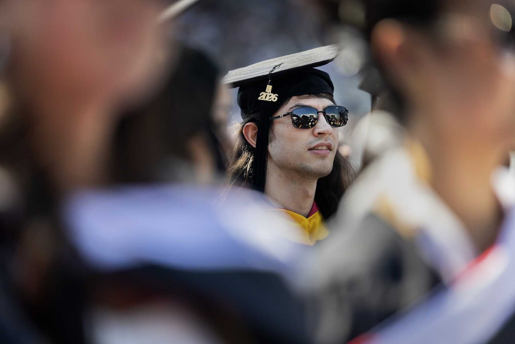 A graduate wearing sunglasses on franklin field.
