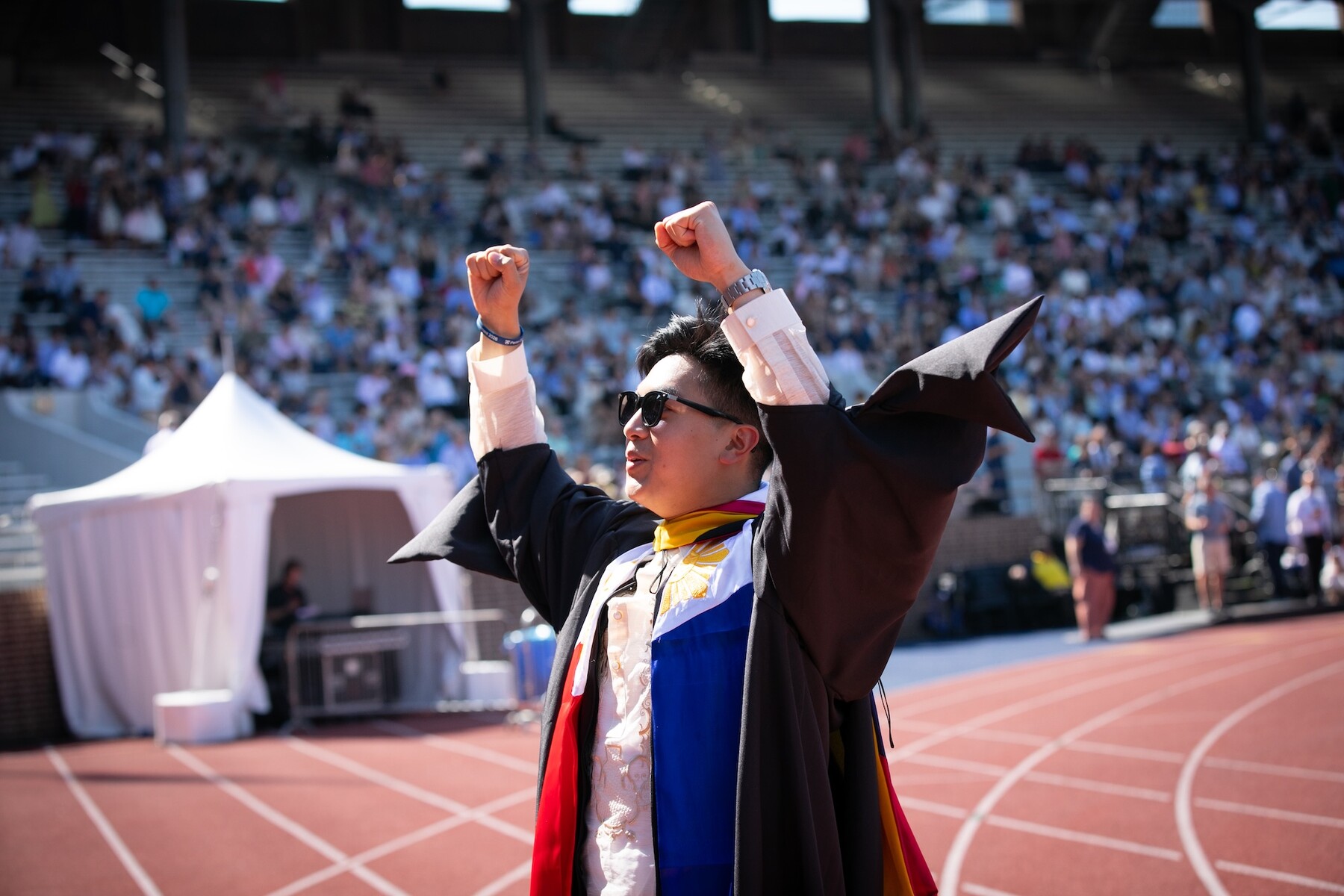 a person raising their fists in celebration on franklin field.