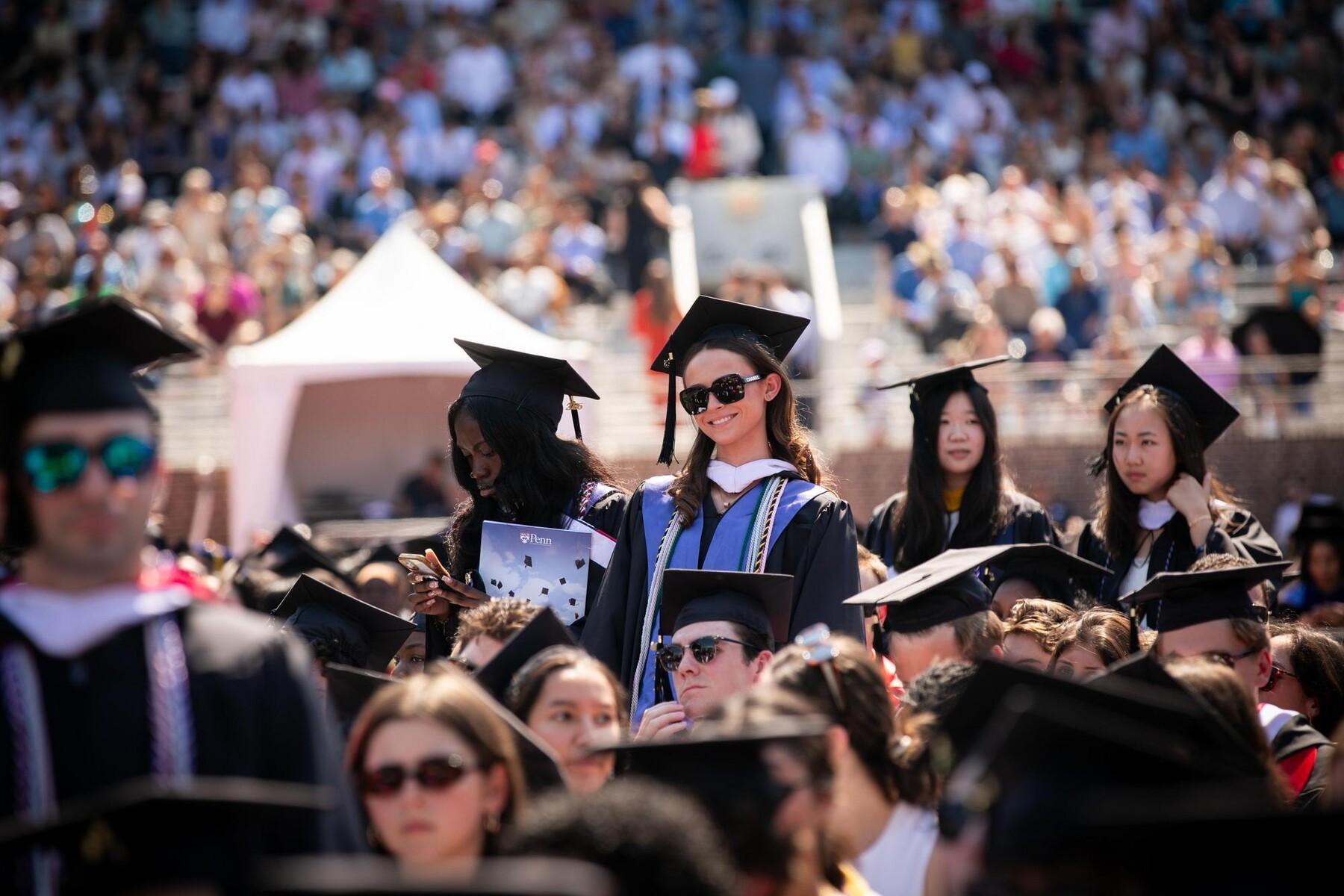 Graduates on Franklin Field during commencement.