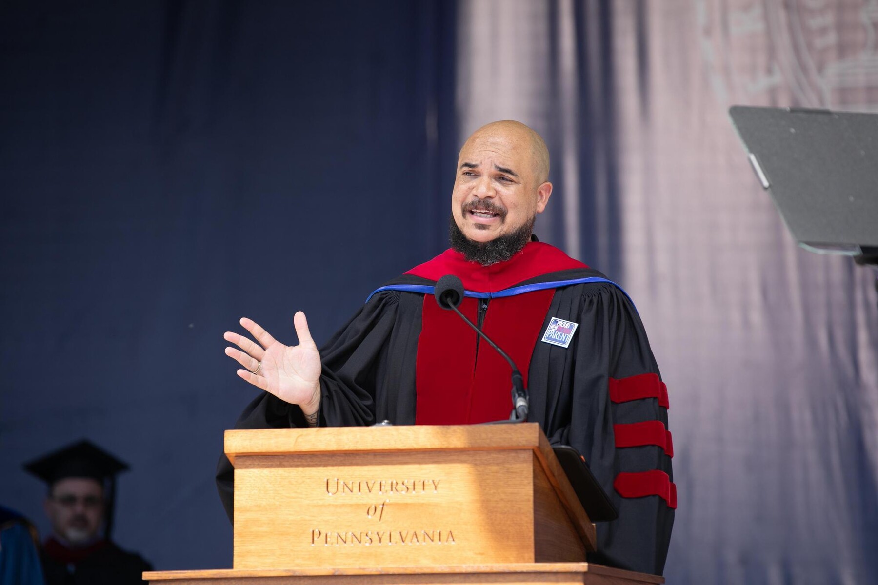 Chaz howard speaking at the podium during commencement.