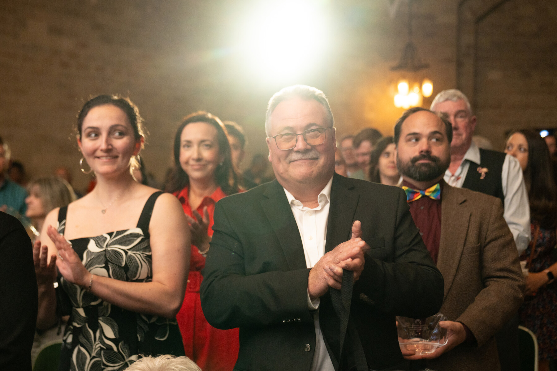 Timothy Grogan clapping in the audience at the Models of Excellence celebration.