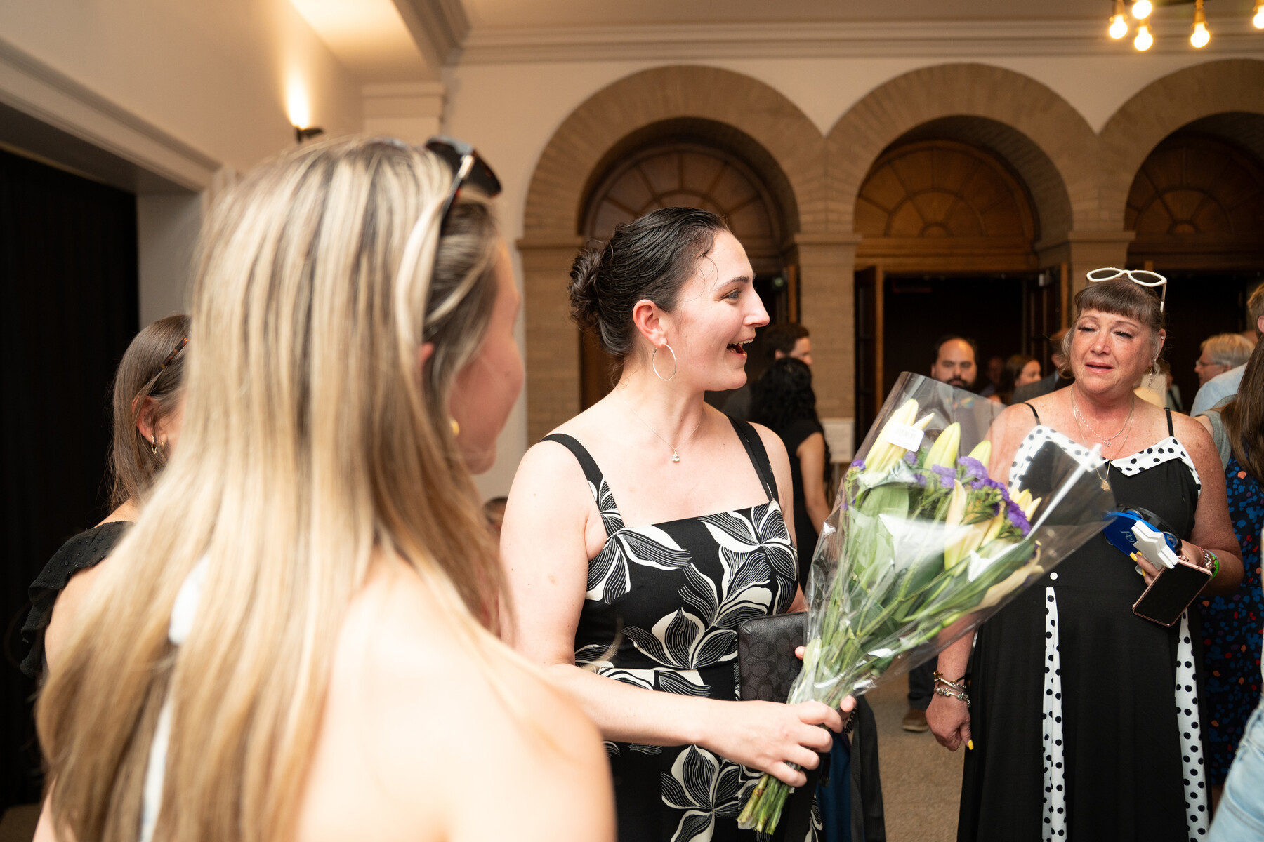 Caitlyn Molony holding flowers at the Models of Excellence celebration.