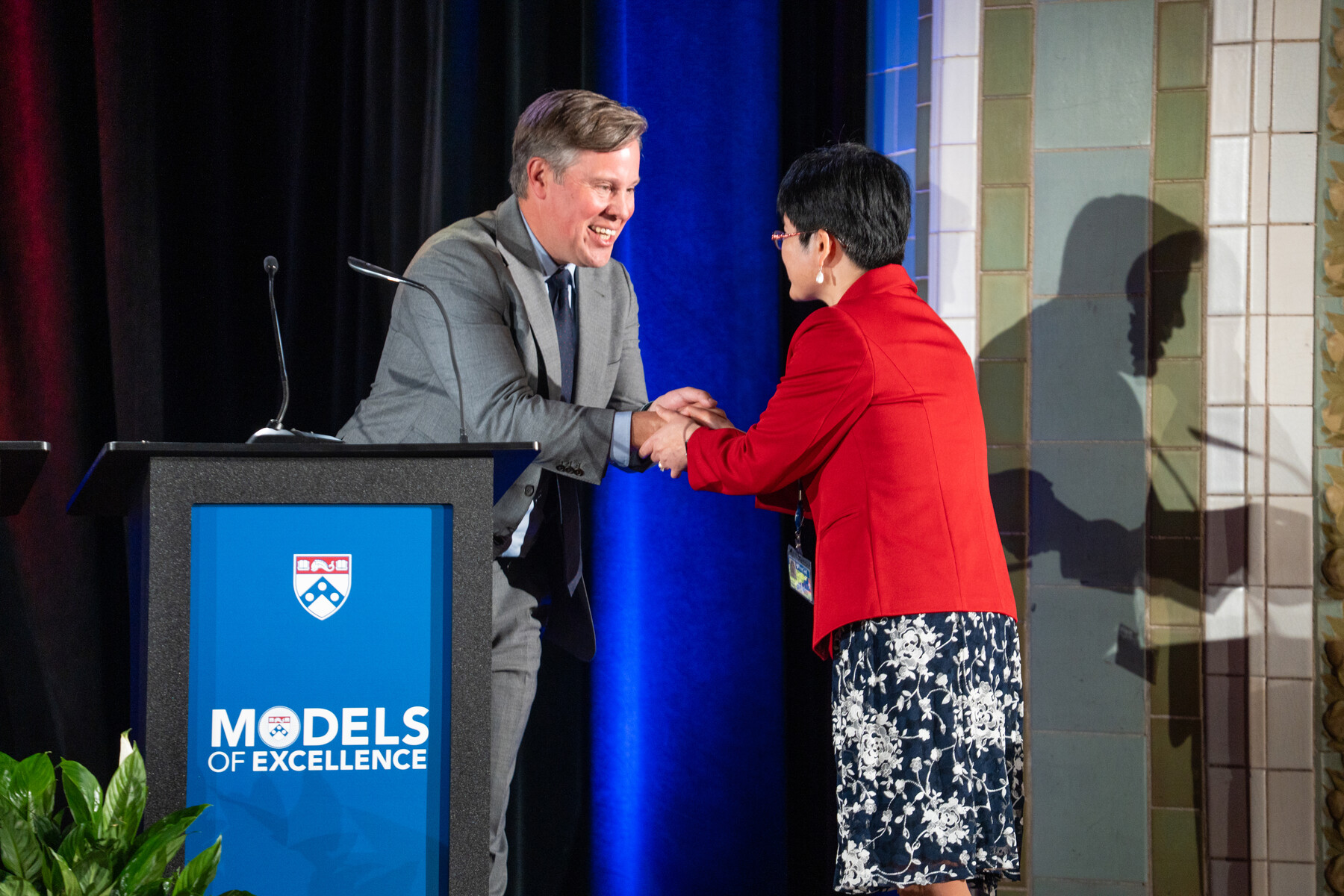 Mark Dingfield shaking Lily Zhang’s hand on stage at the Models of Excellence celebration.