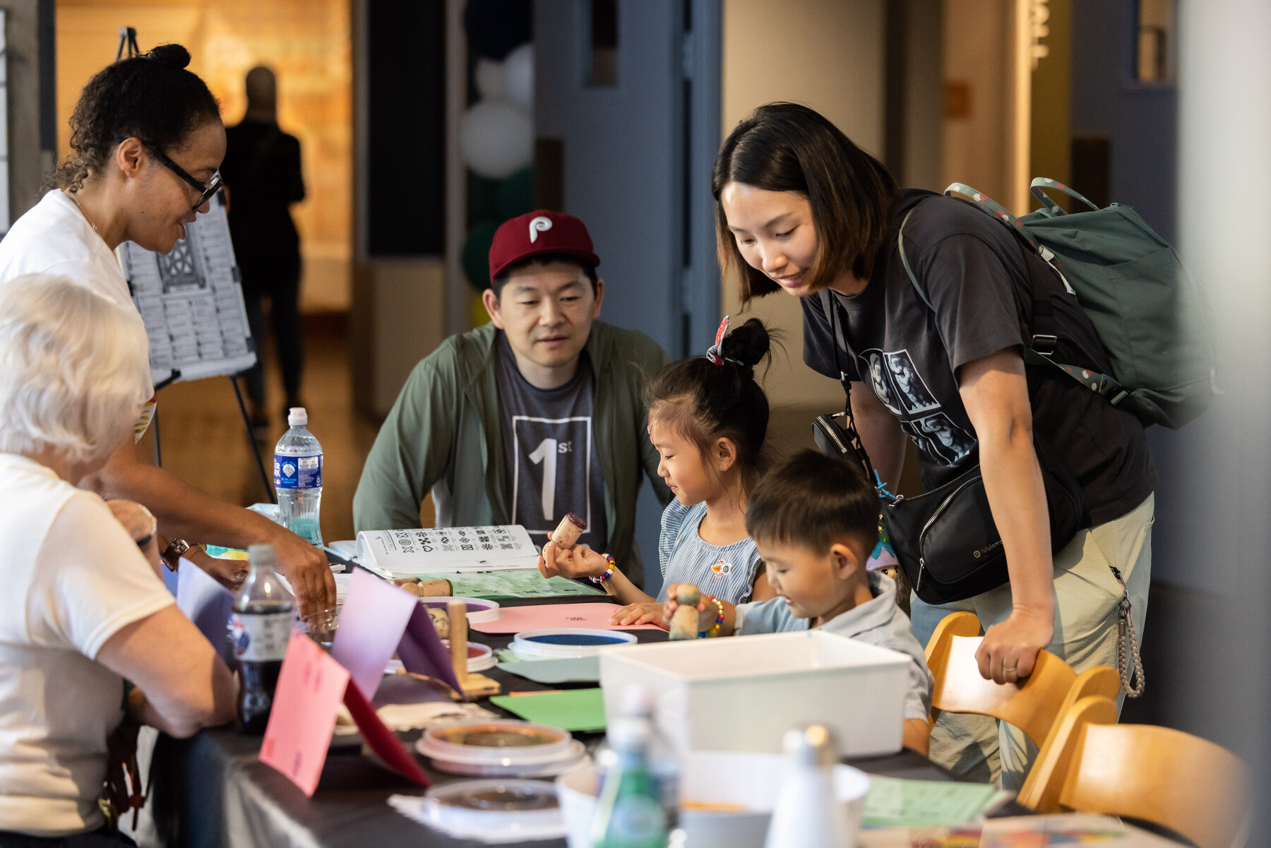 A family doing crafts at a table at the Penn Museum.