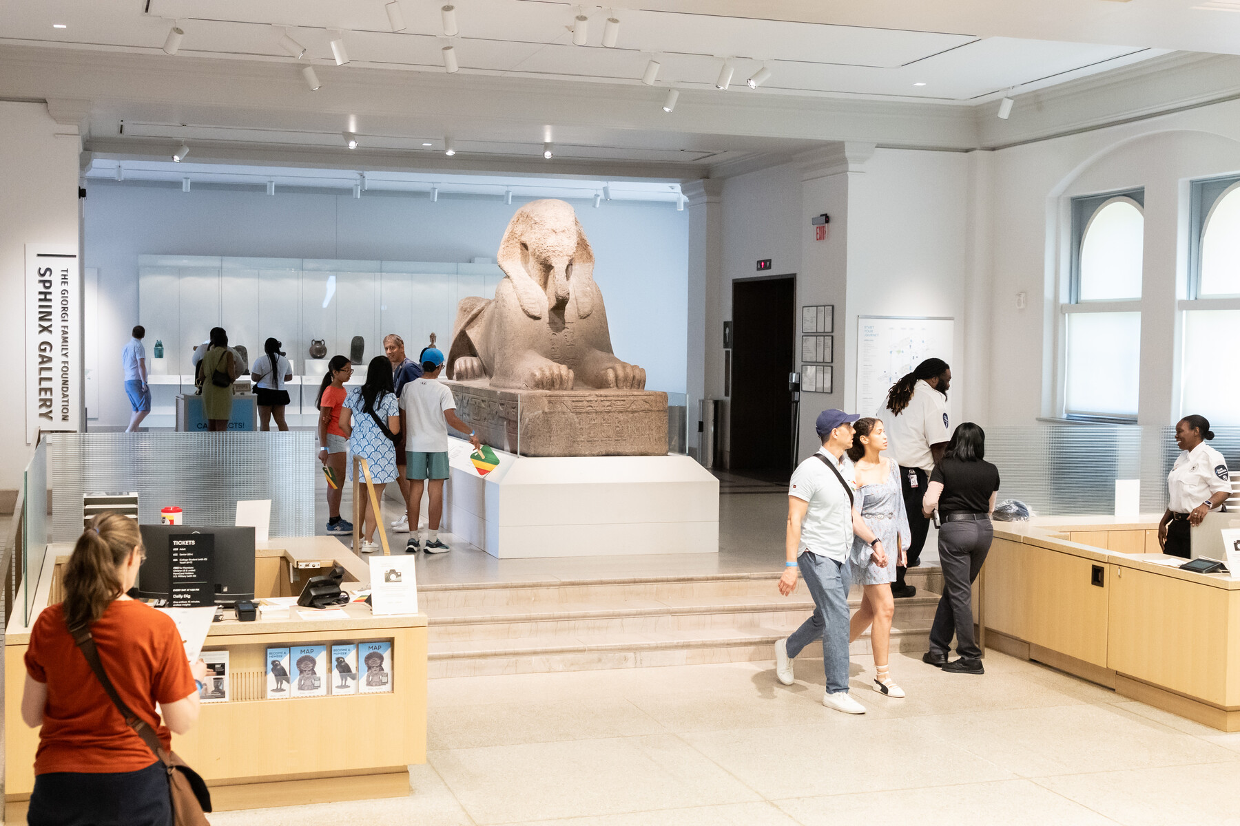 Visitors at the Penn museum looking at exhibits including the Sphinx.