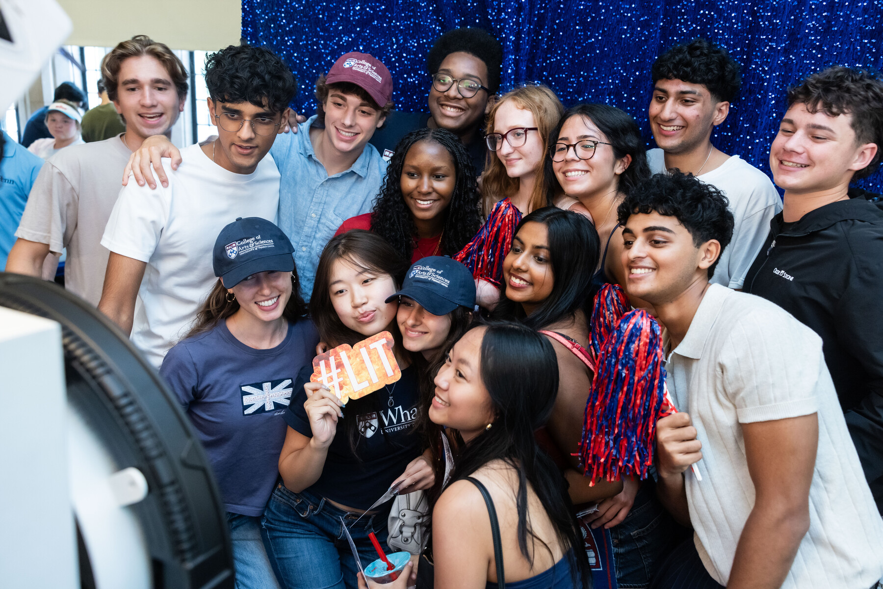 Penn students posing in front of a photo booth.