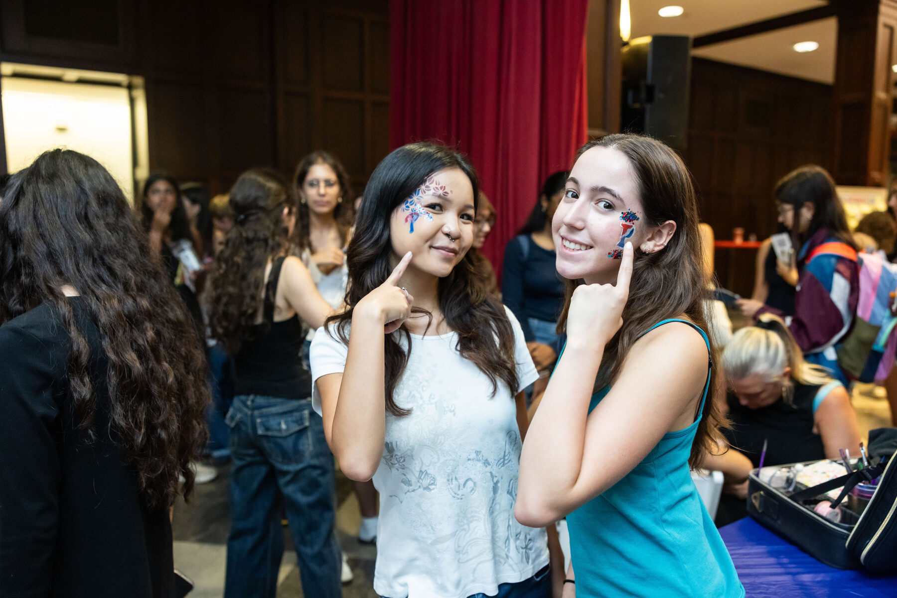 Two Penn students with Penn-themed face paint in Houston Hall.