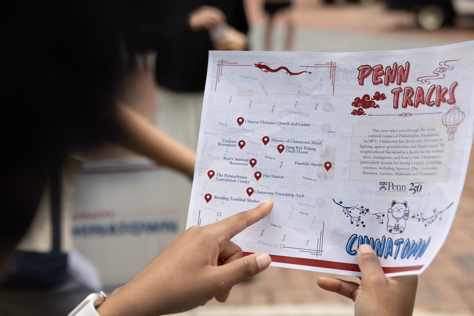 A student holding Penn Tracks map