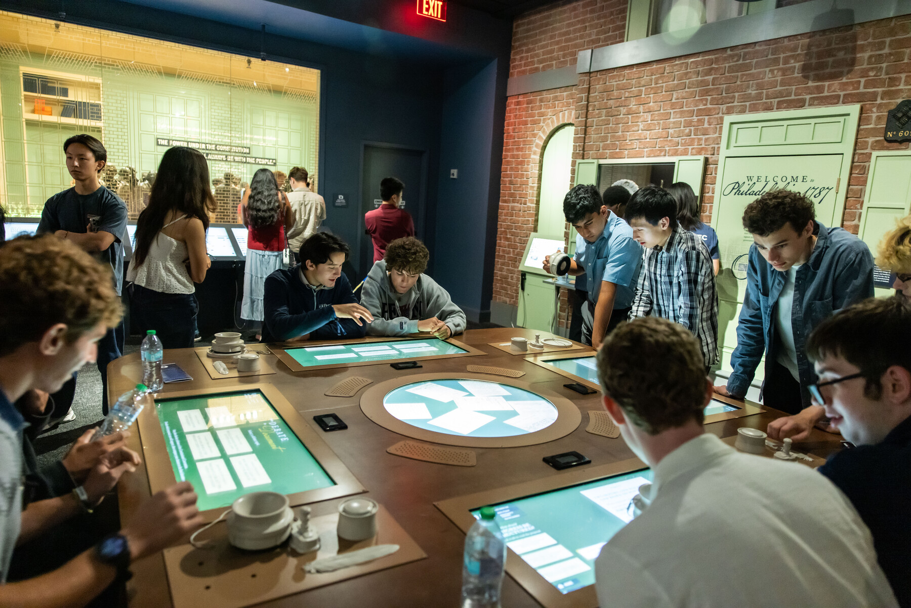 Penn students reading information at exhibits at the Constitution Center.