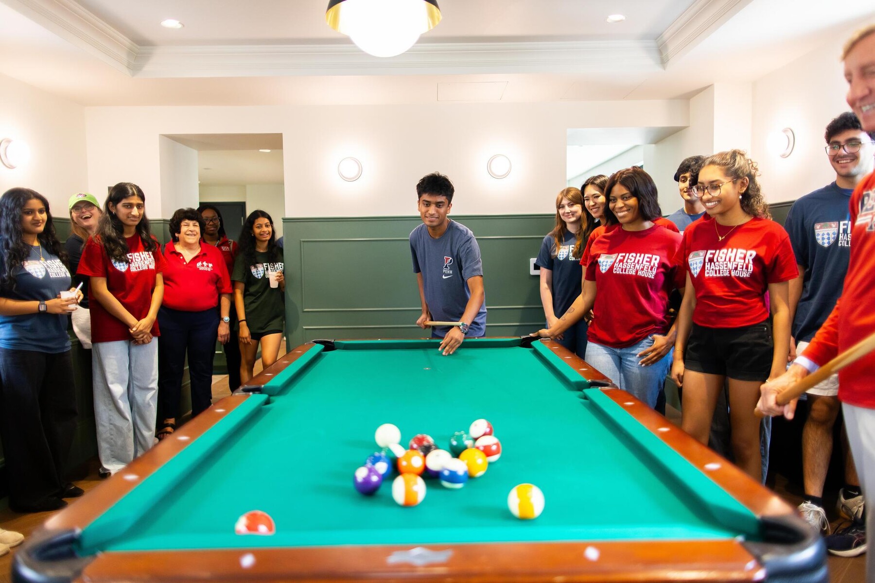 Students around a pool table at Fisher Hassenfeld dorm.