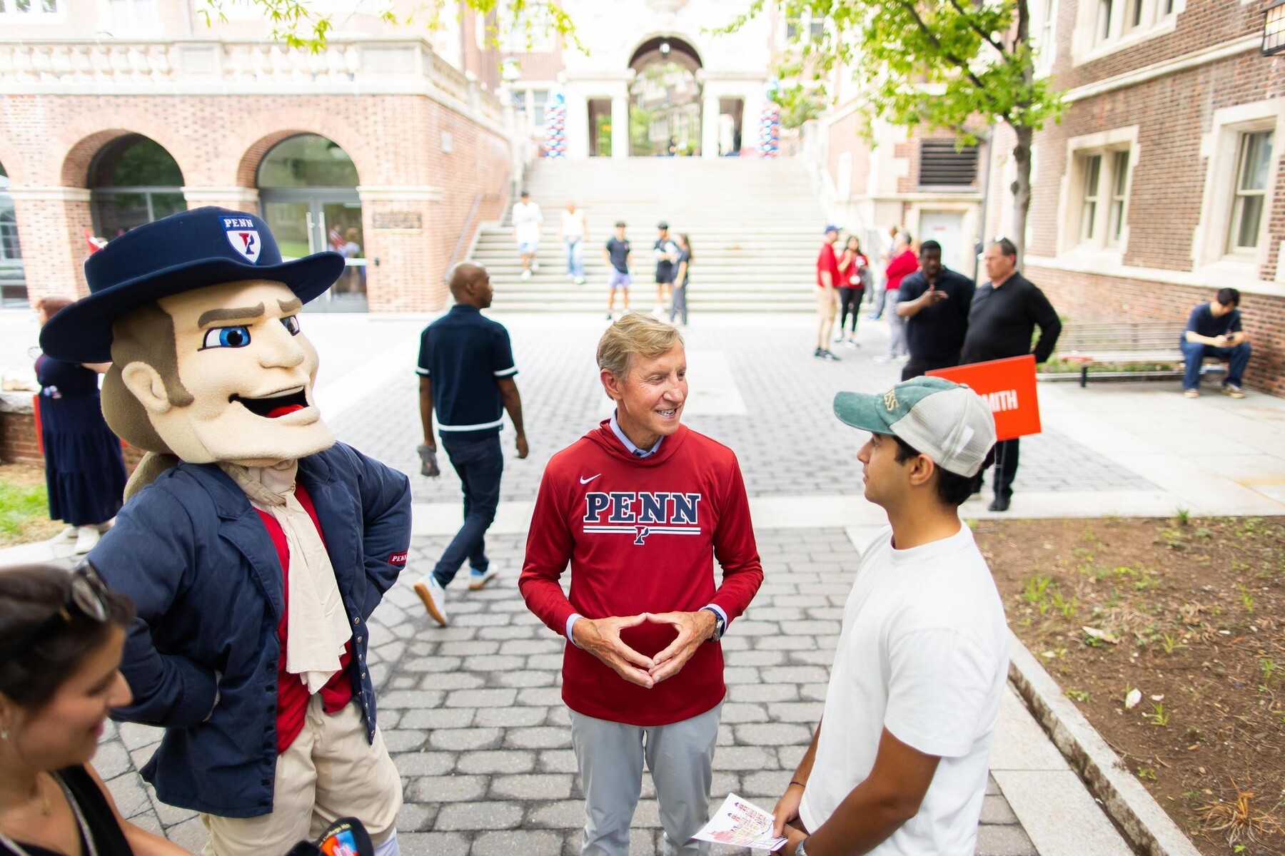 The Penn Quaker and J. Larry Jameson talking to a student outside the Quad during Move-In.