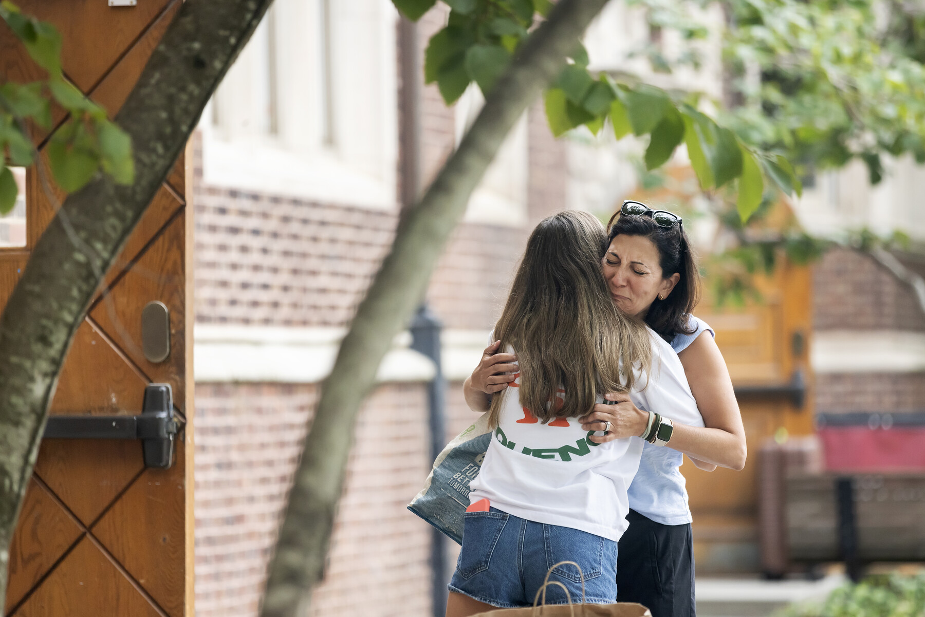 A parent hugging their child outside the Quad on Move-In.