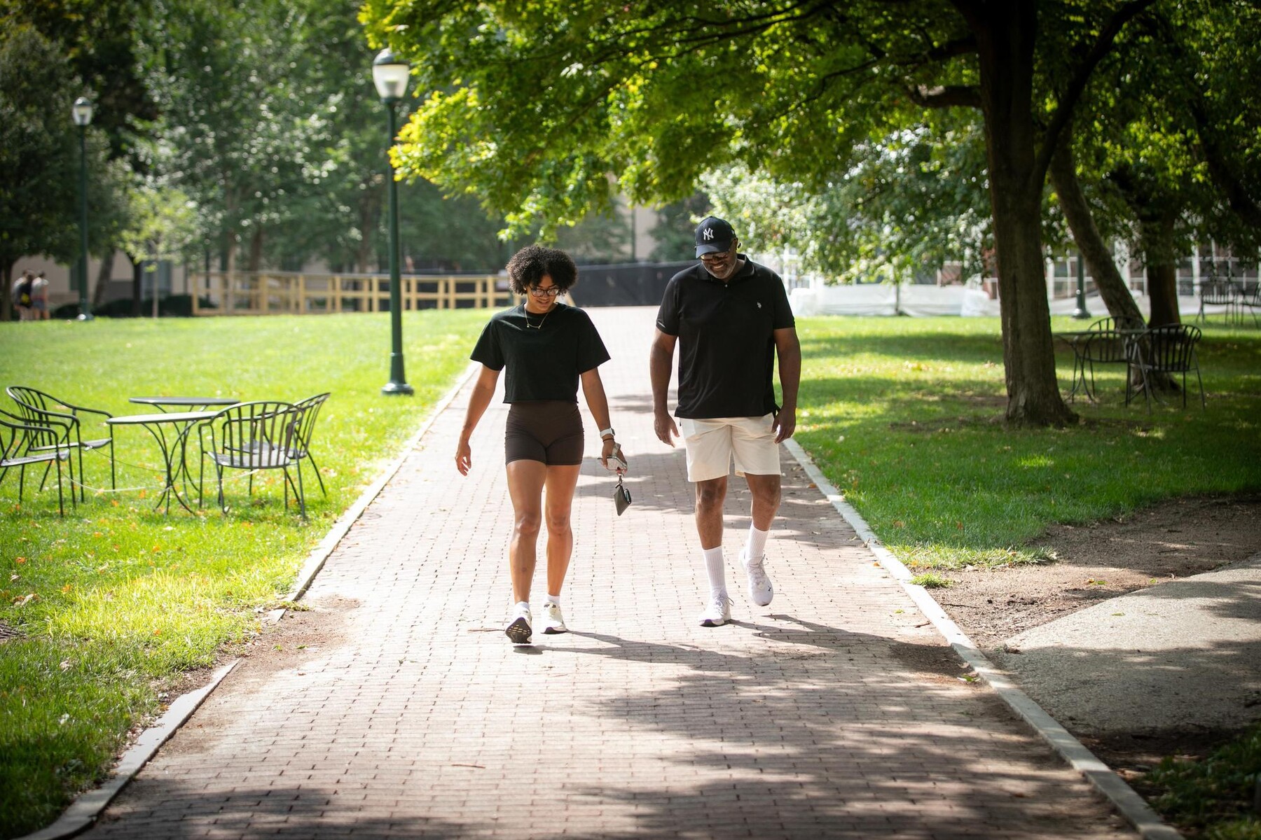 A parent and student walking down Locust Walk during Move-In.