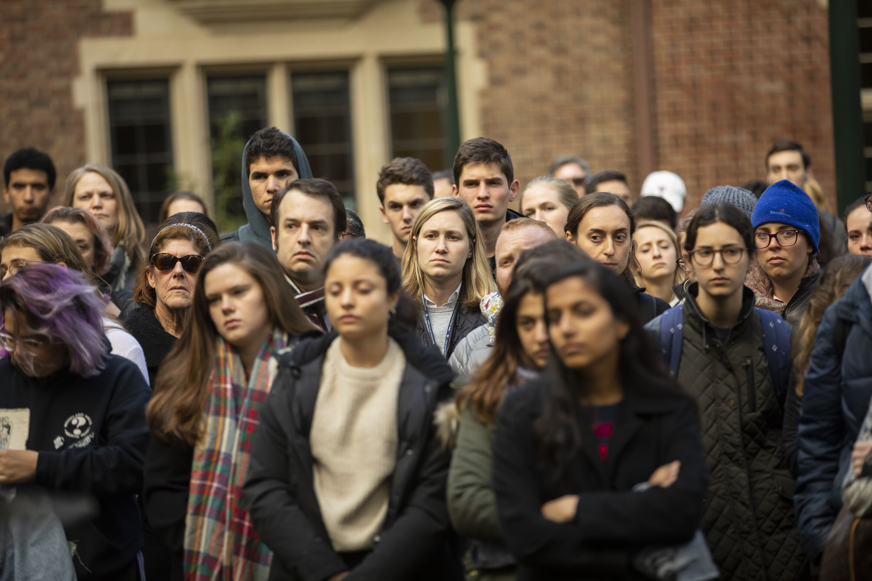 the camera faces the crowd at the vigil