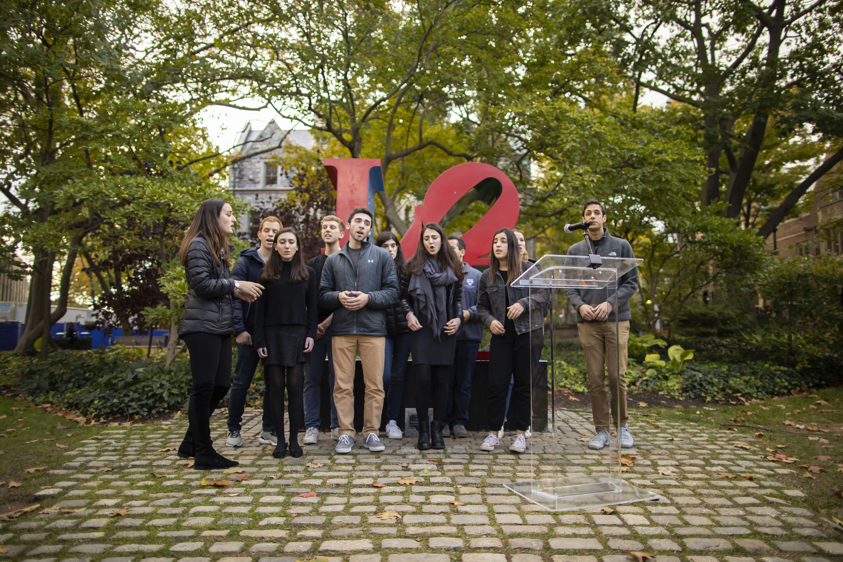 the musical group the Shabbatones singing in front of the LOVE statue