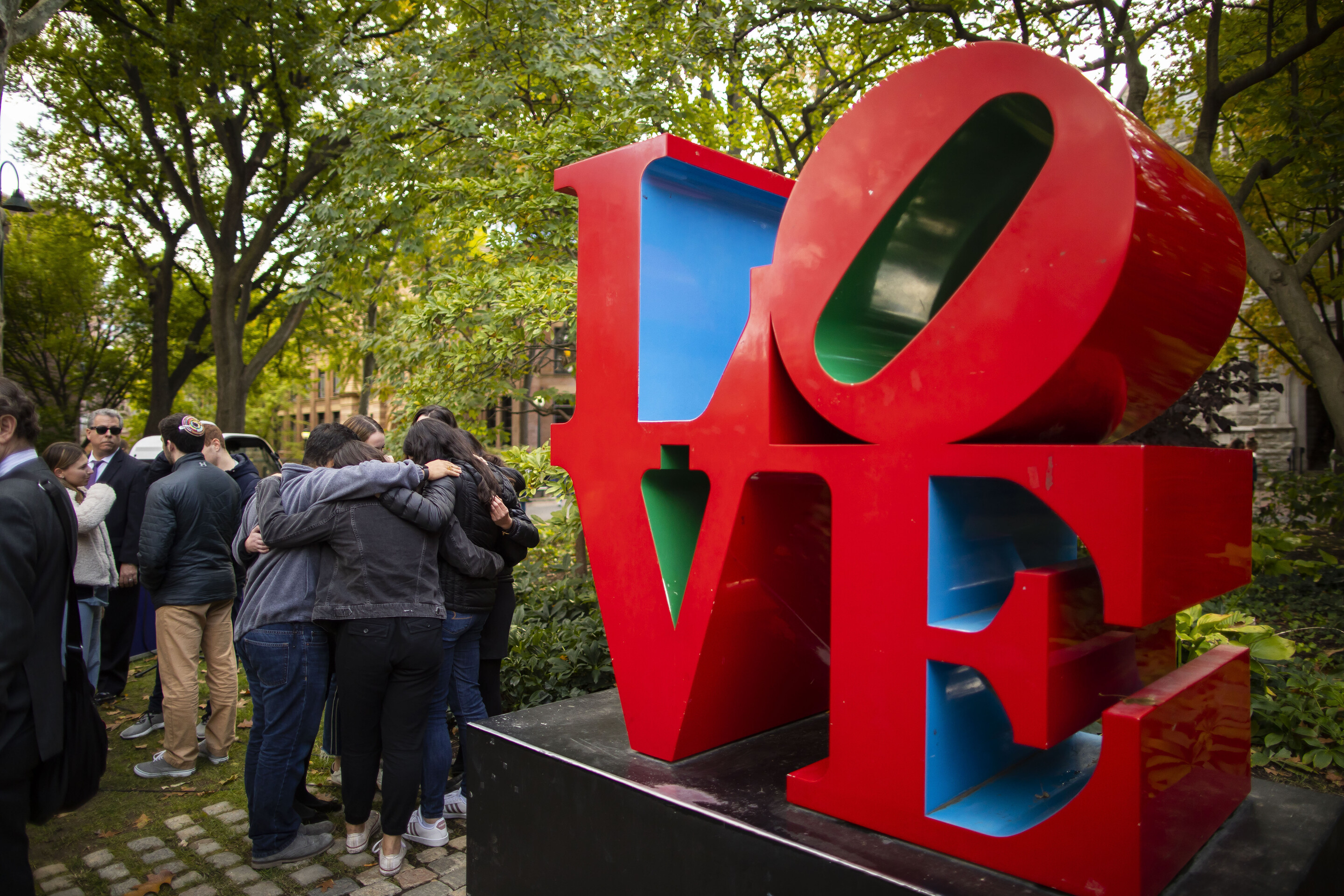 The LOVE statue and students hugging off to the side