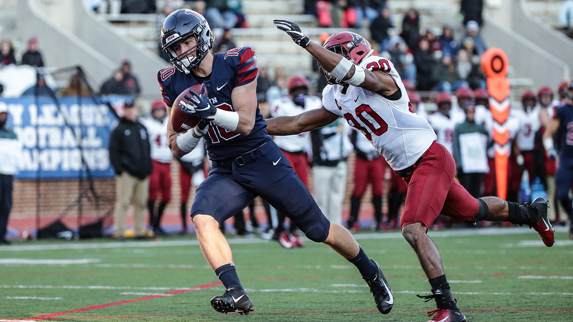 football-player-with ball-running-on-field-to avoid-tackle