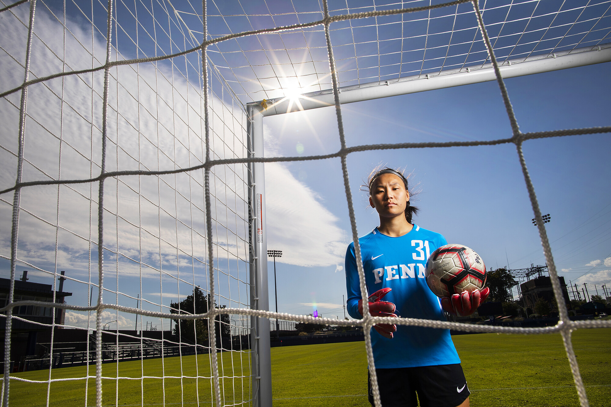 Qu poses in goal on Rhodes Field with soccer ball