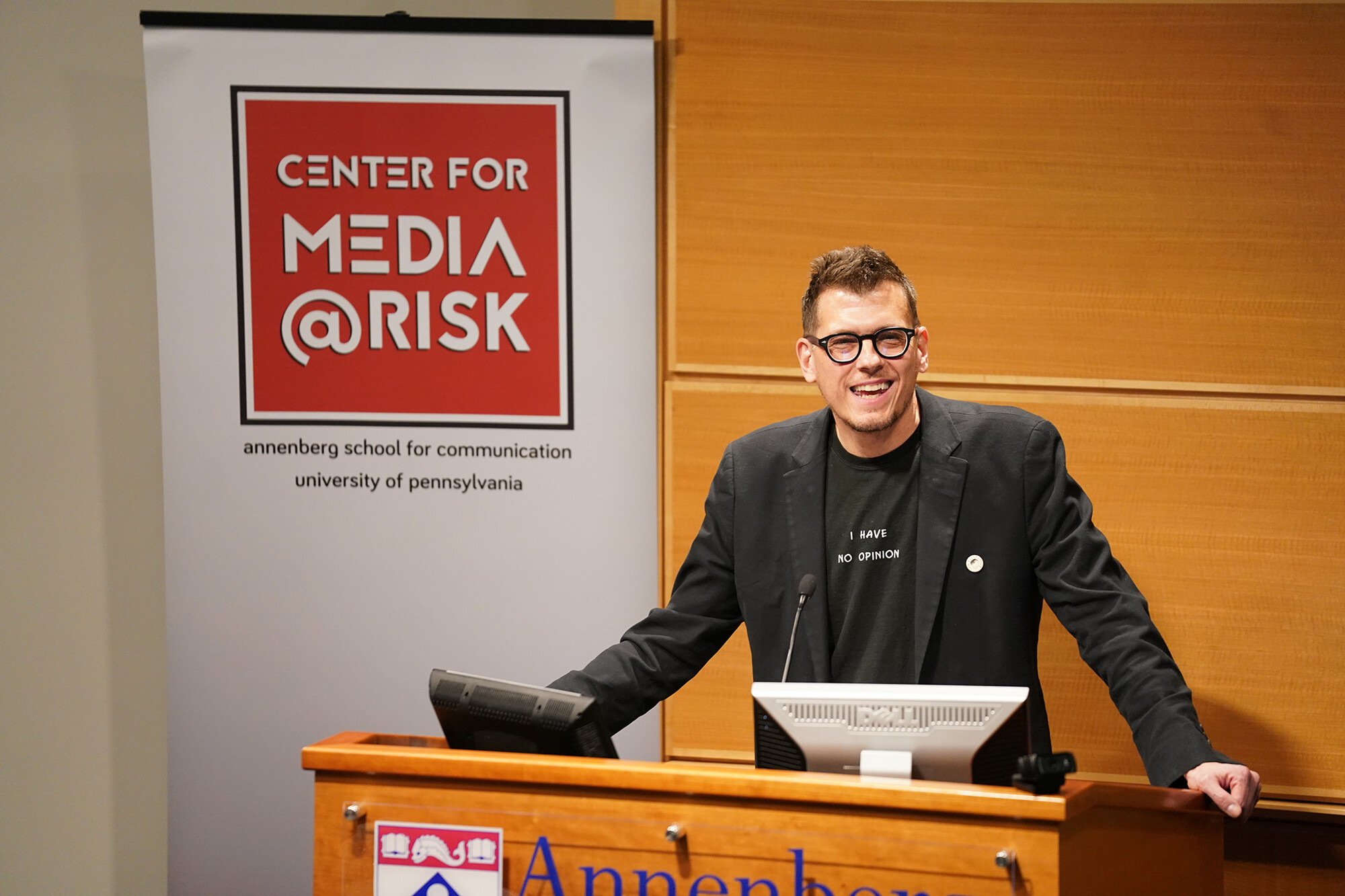 Mr. Fish teaches in a classroom with the Center for Media at Risk logo in the background
