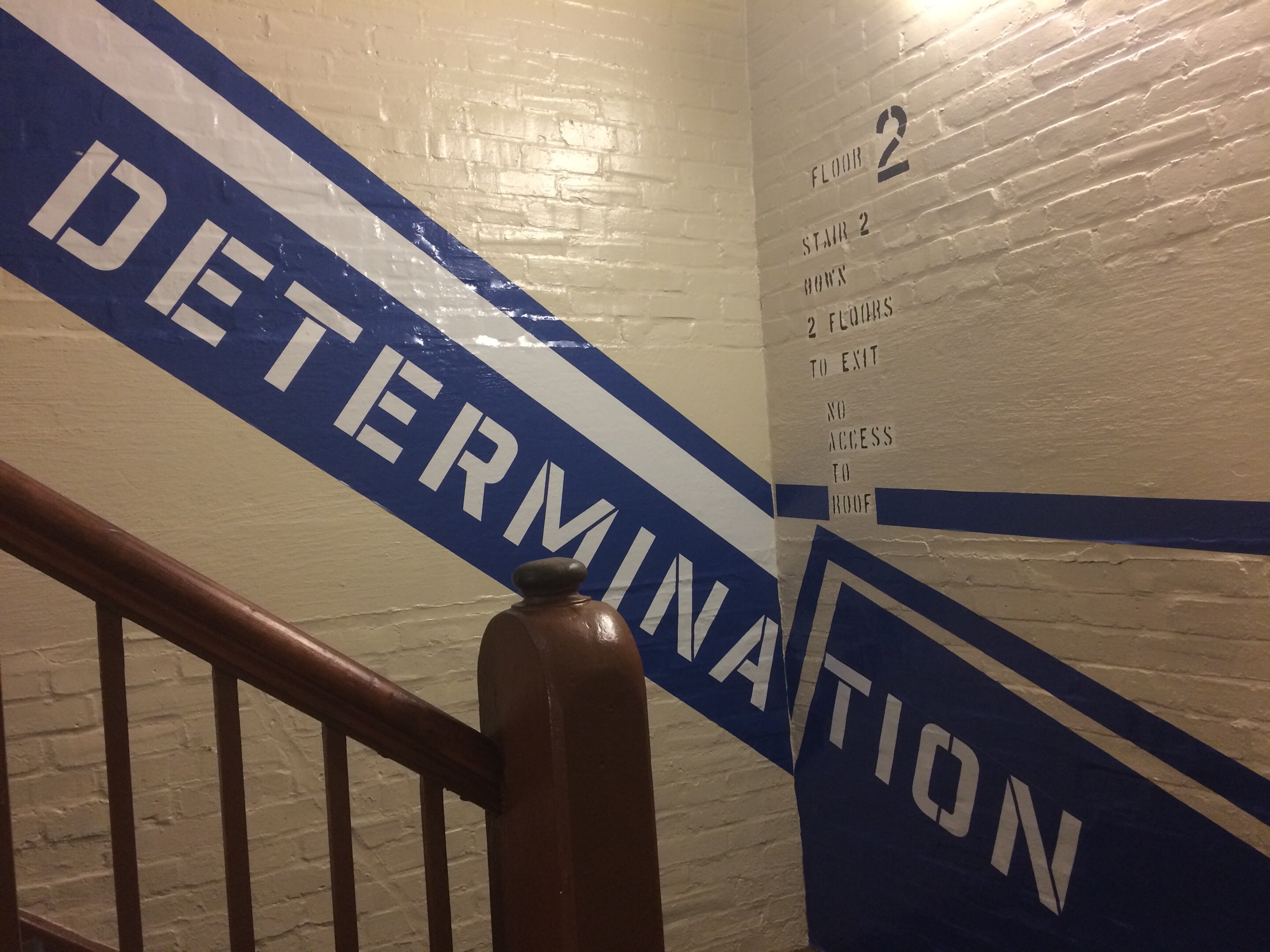 Blue stripe with Determination written on it in stairwell