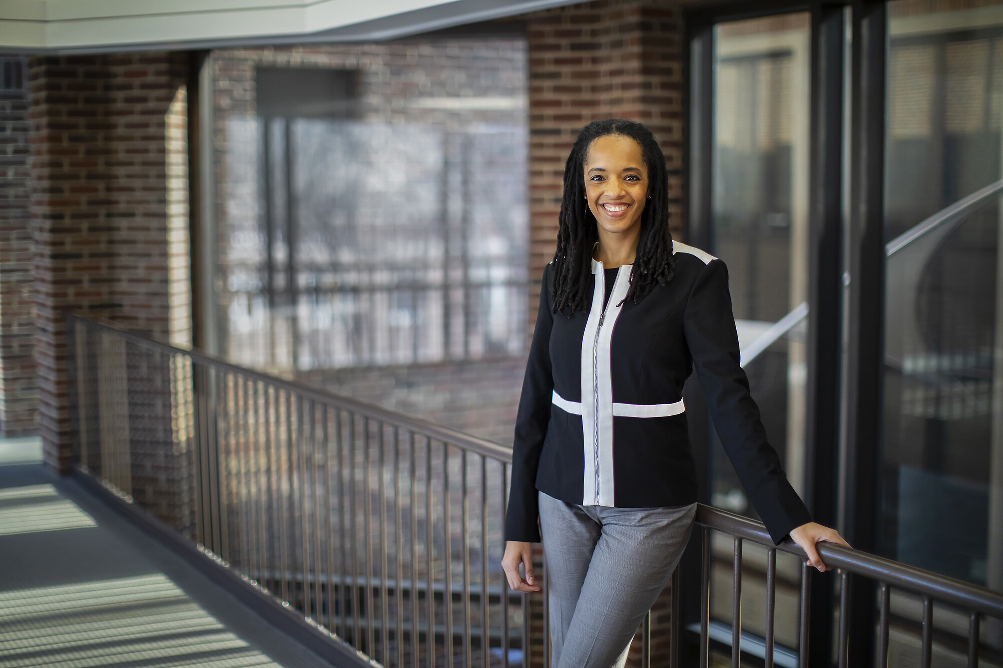 Stephanie Creary of Wharton poses along a railing in Steinberg Hall-Dietrich Hall. 