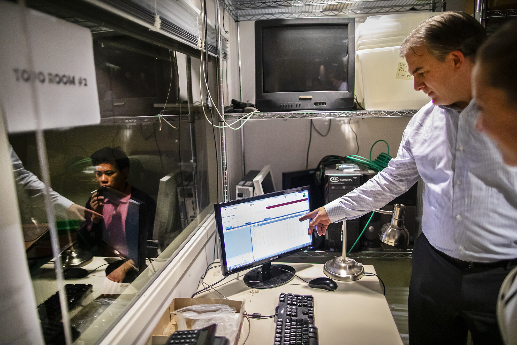Andrew Strasser pointing to a computer screen