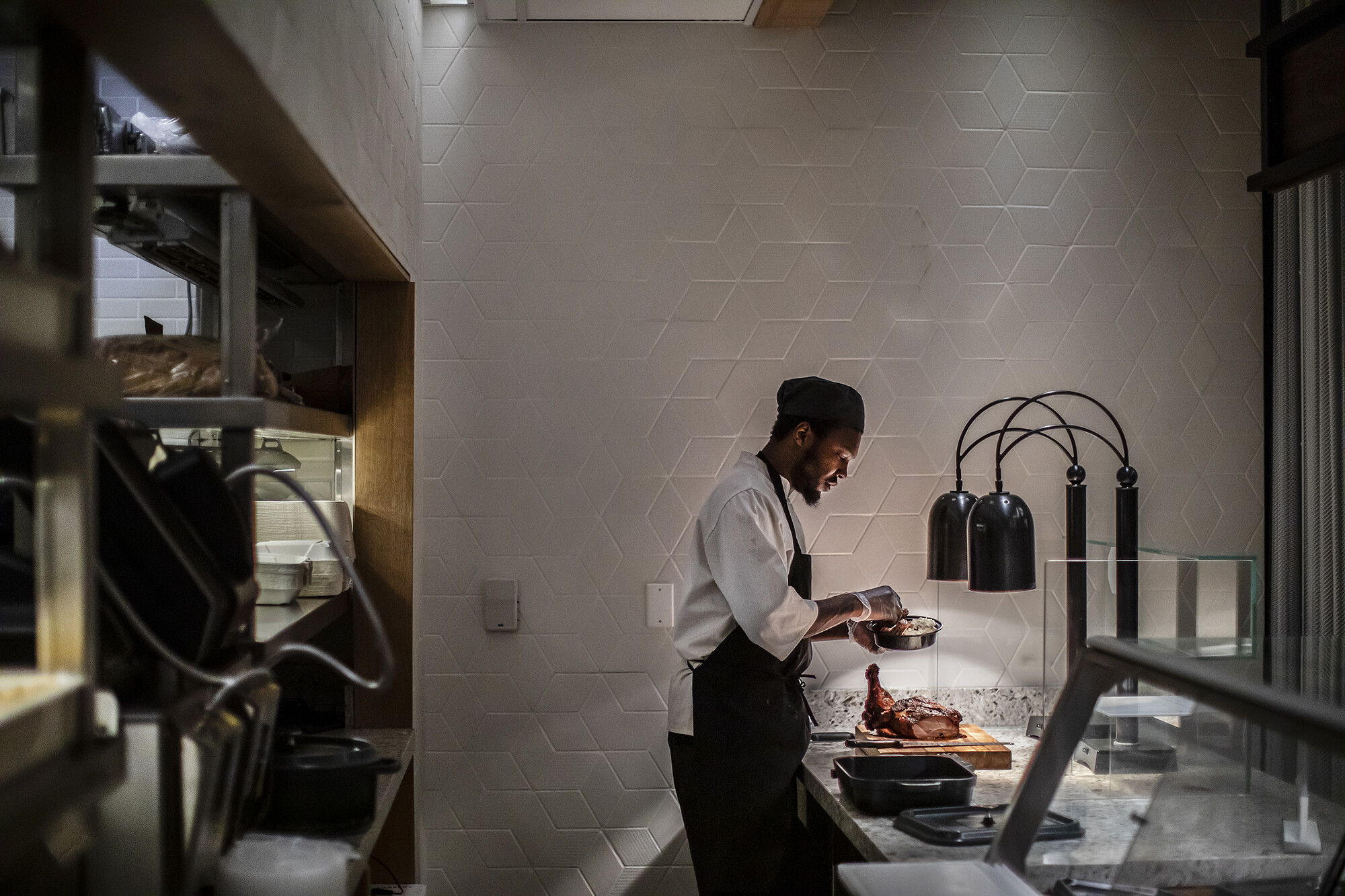preparing chicken behind the counter at penn dining