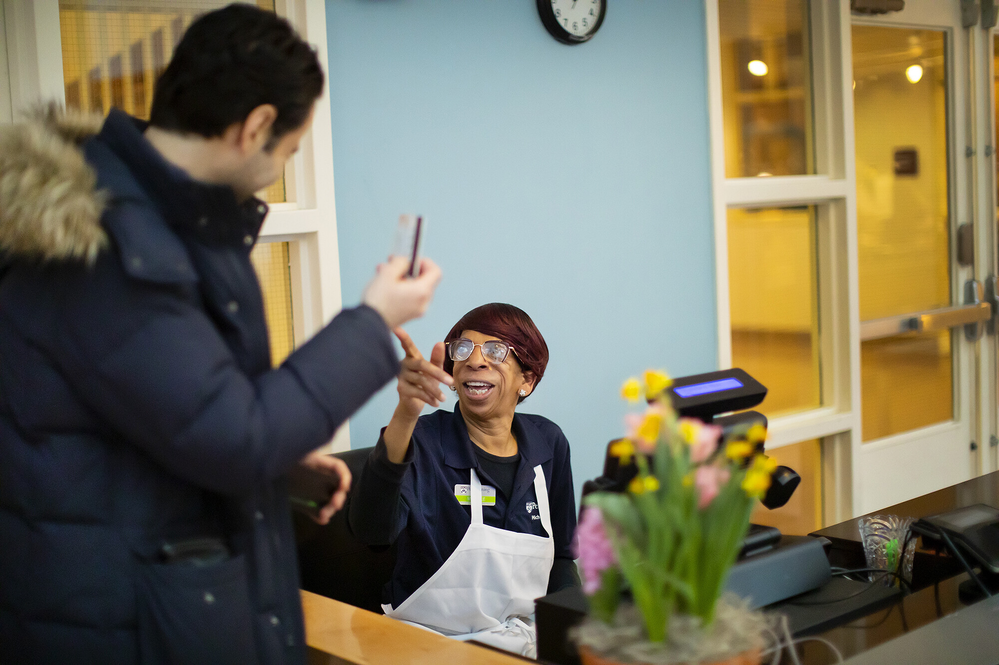 student talking to penn dining cashier