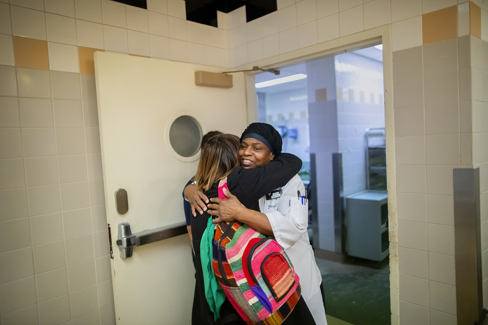 student hugging penn dining cook