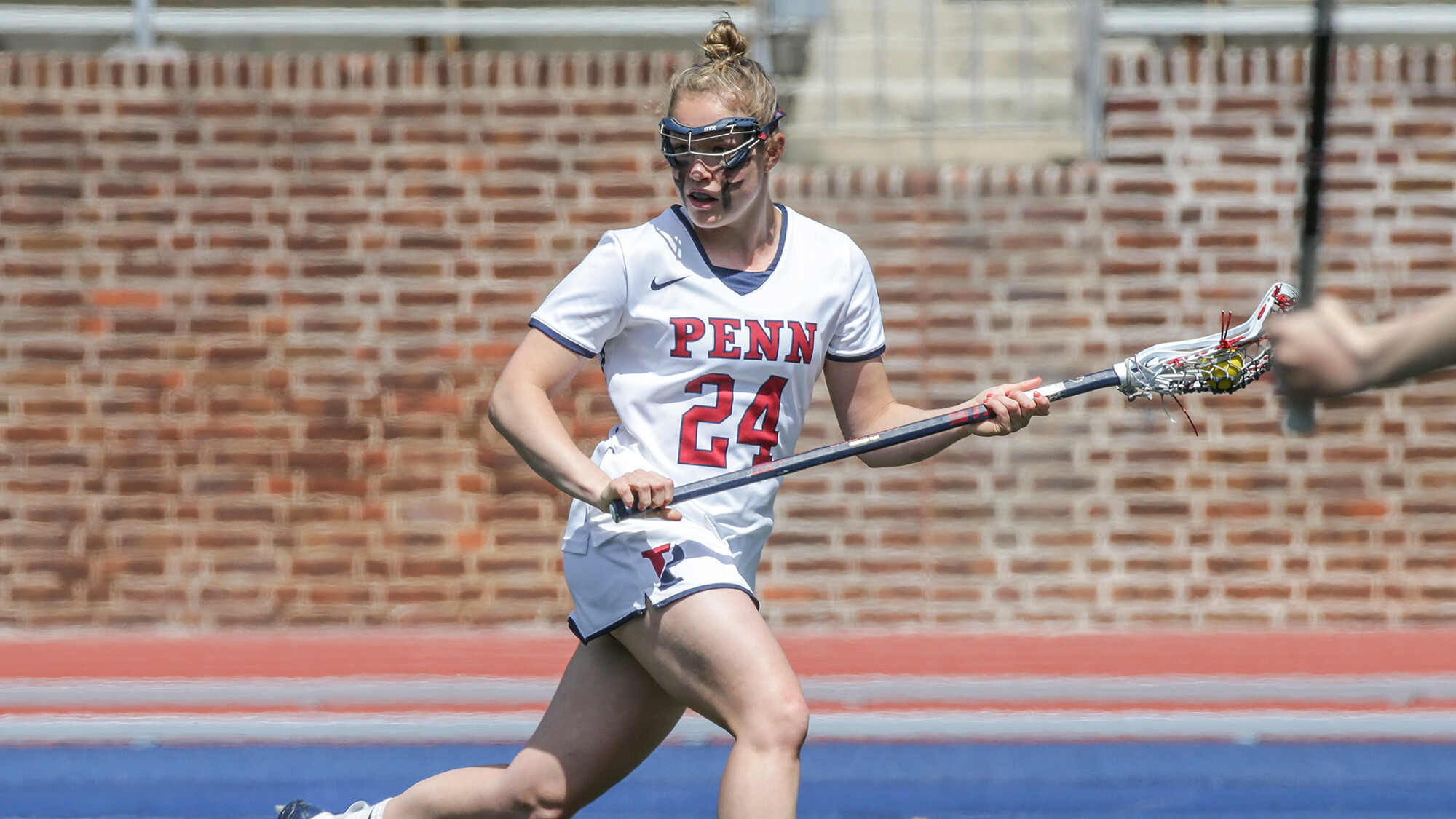 Gabby Rosenzweig attempts to score with the ball in her stick.