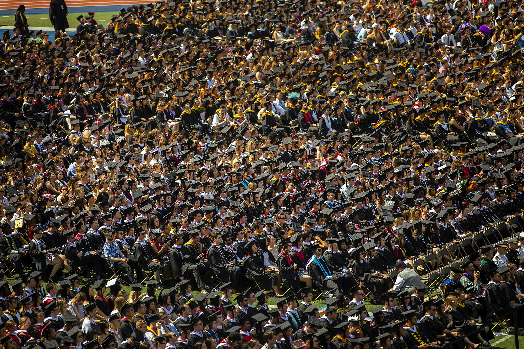 Crowd shot of graduates seated on Franklin Field