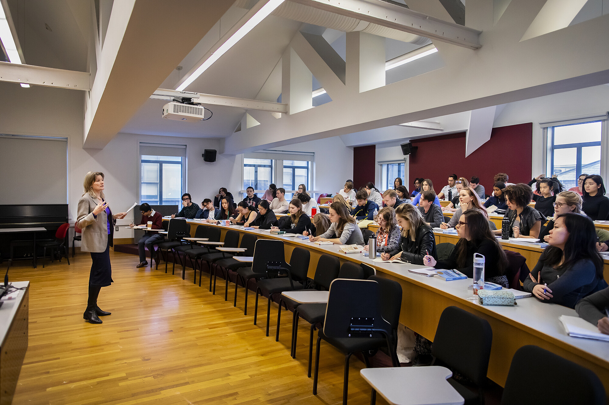 Jennifer Egan stands with book in hand lecturing class.