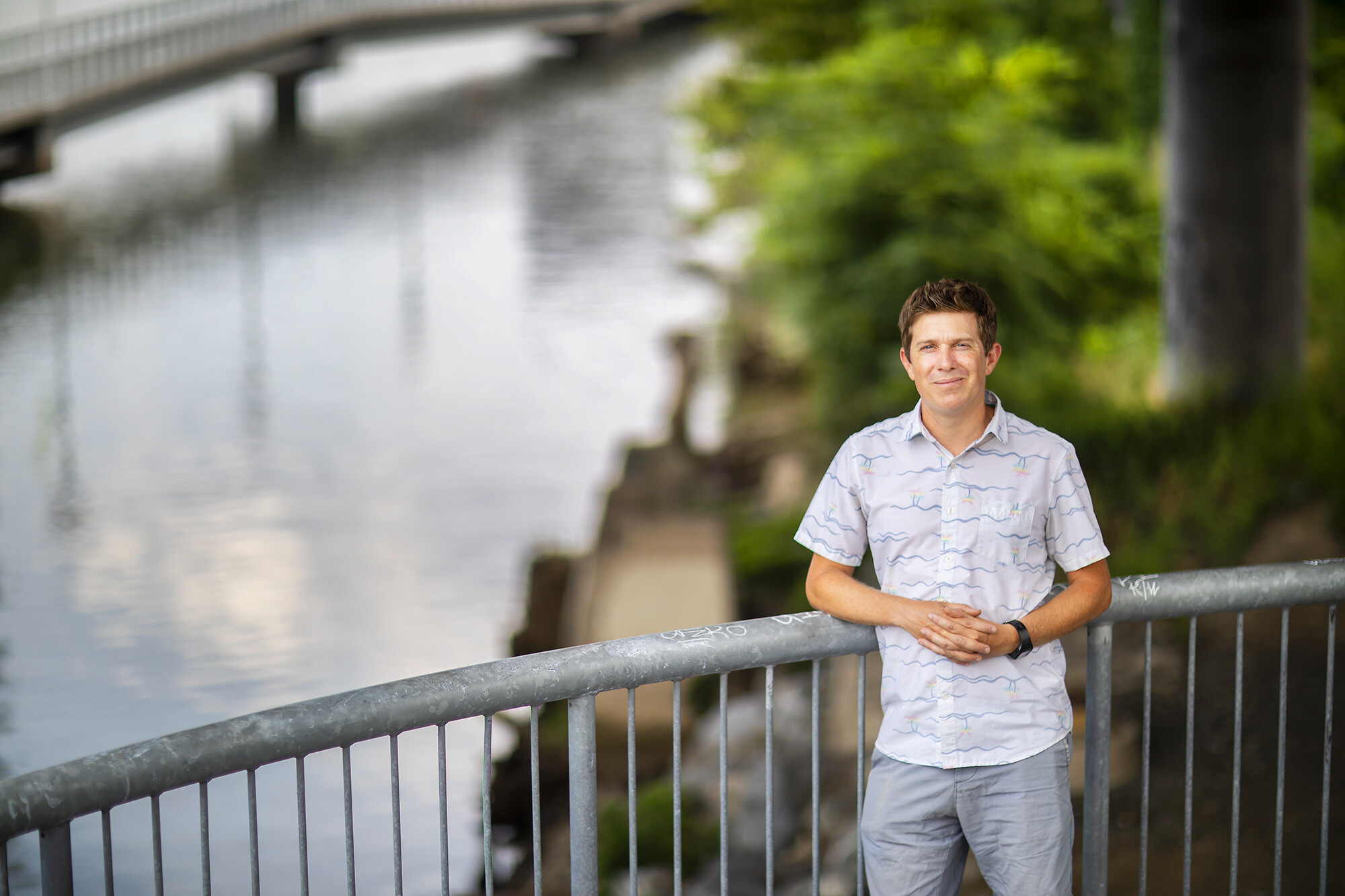 Doug Jerolmack leans against railing with river in background