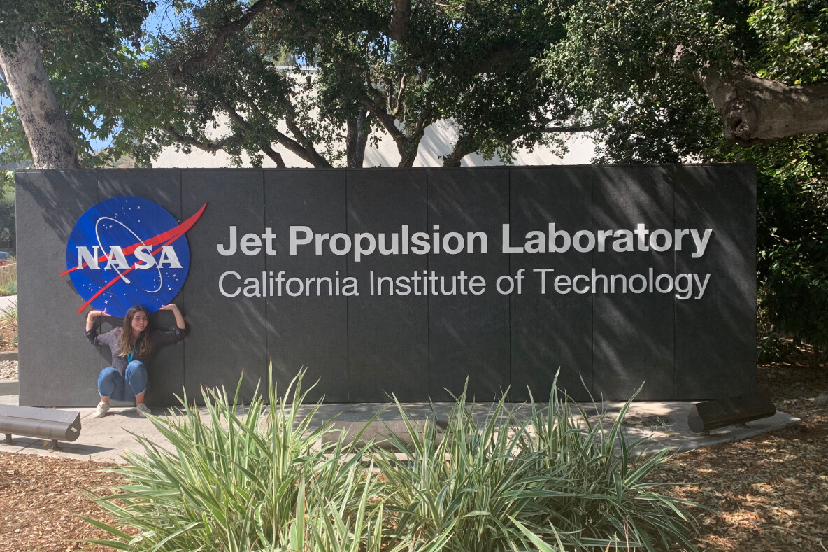 alex ulin standing in front of the jet propulsion laboratory sign, under the nasa logo and next to text that reads california institute of technology