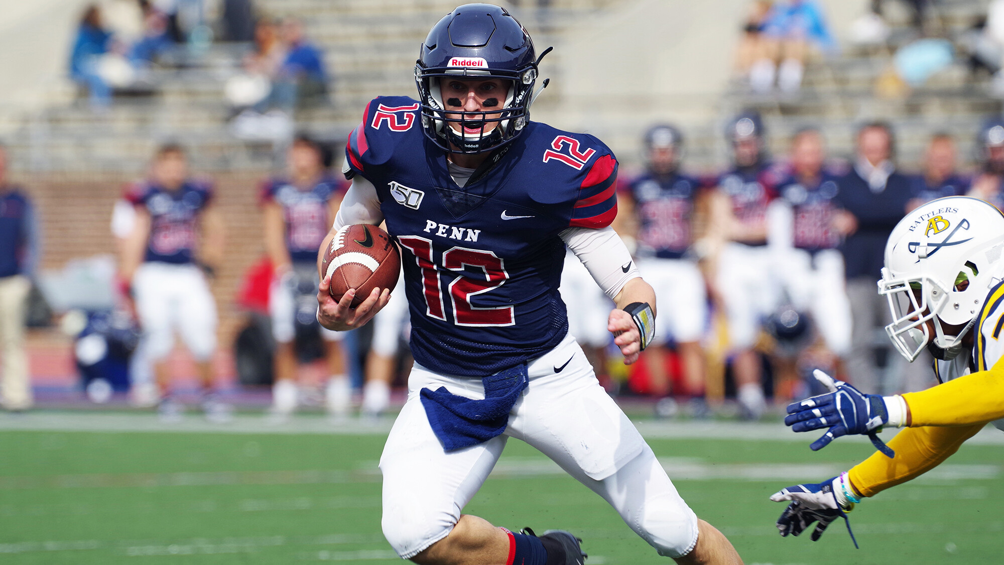 Against Alderson Broaddus at Franklin Field, quarterback Eddie Jenkins of sprint football makes a move with the ball in his hand.