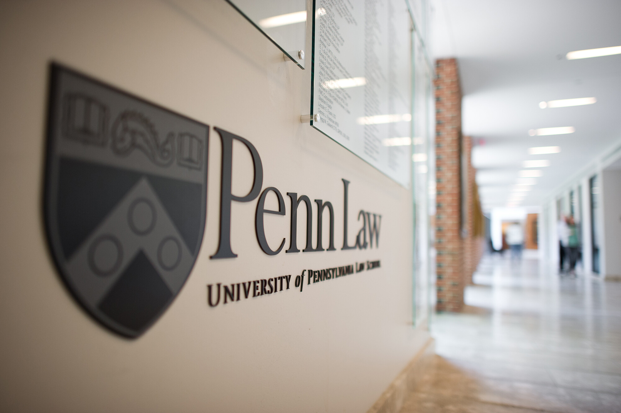 Penn Law shield on the wall in the hallway of a Penn Law building